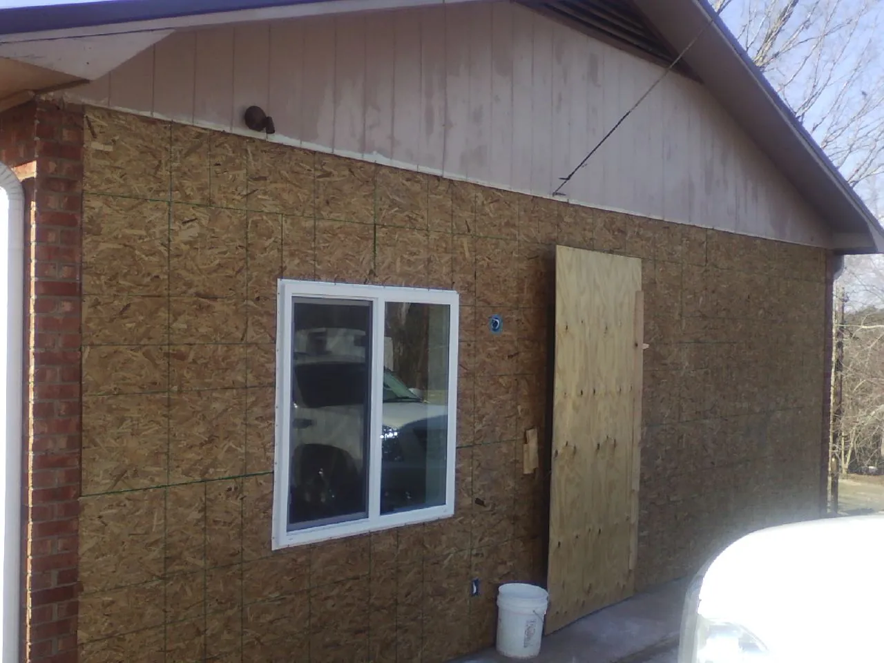 OSB sheathing on a garage addition wall before siding in Irvington