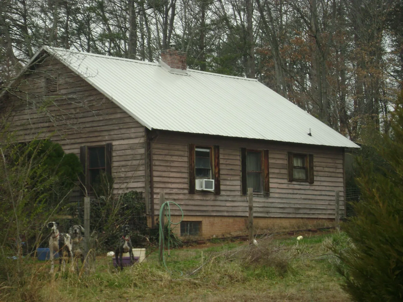 White metal roof on an old wood sided farmhouse, from a Asphalt Shingle Roof Repair job in Irvington